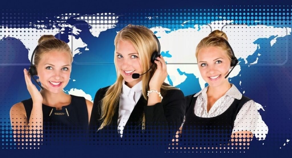 Three customer support representatives wearing headsets against a blue global map background.